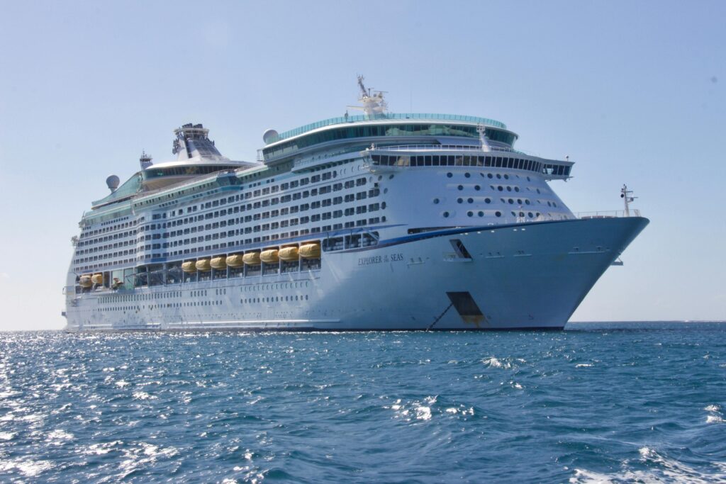 Home A luxurious cruise ship sailing on the ocean under a clear blue sky, ideal for travel and leisure.